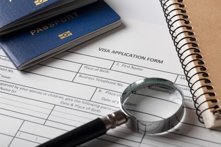 UK immigration visa application form with passports and magnifying glass for Redbridge Solicitors visa guidance services.